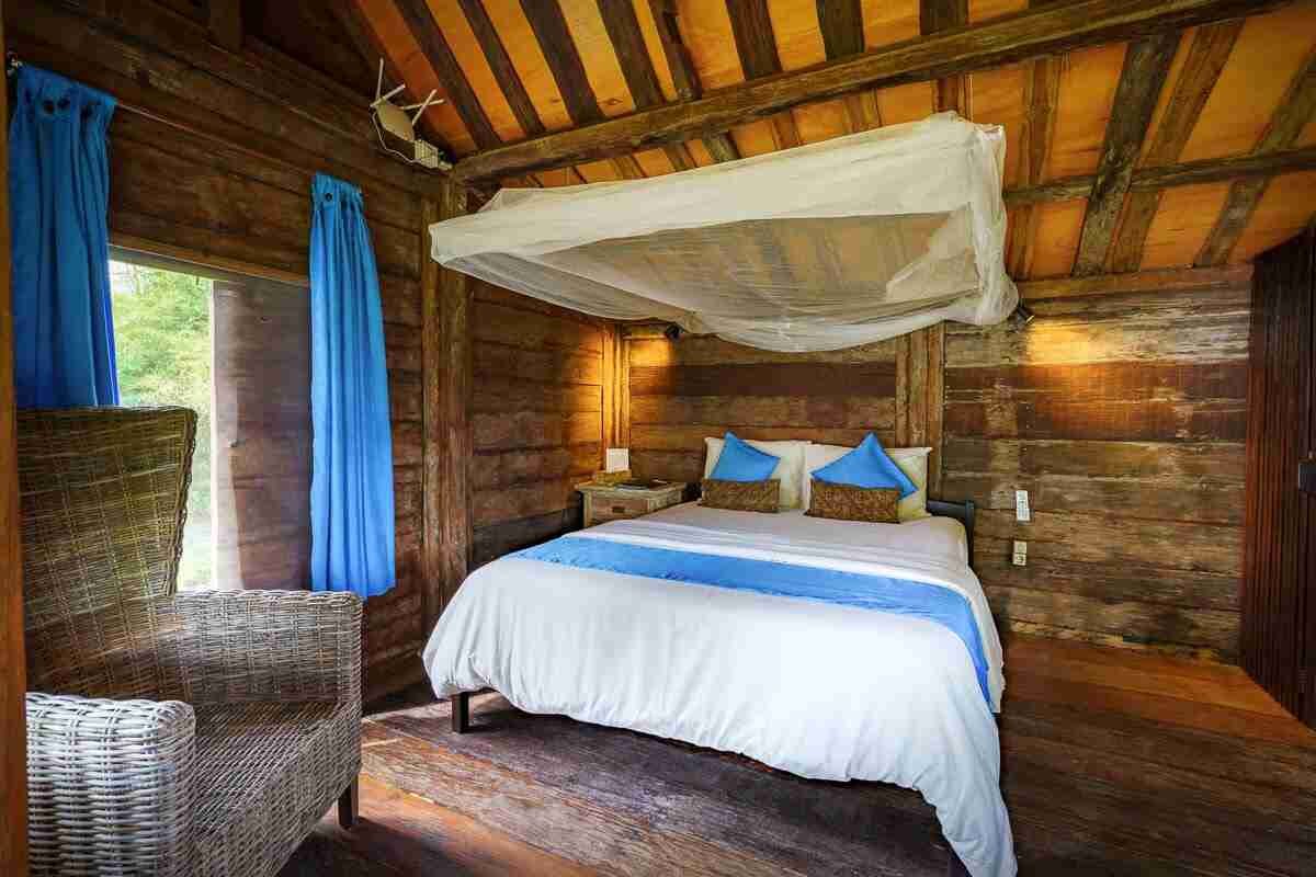 Teak bedroom inside The Joglo by the Sea